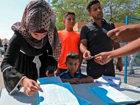 Bedouins from the Negev register to vote outside a polling station in Beersheva in southern Israel during the Jewish state's parliamentary election on September 17, 2019.