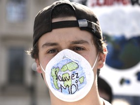 A protester wears a mask that reads "Save Me" during a Global Climate Strike, protesting against climate change and inaction, on Parliament Hill on Friday, Sept. 27, 2019.