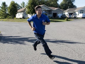 Pierre Poilievre, Conservative candidate for Carleton, runs to the next house while campaigning door to door ahead of the 2019 federal election, in the Ottawa community of Greely, on Tuesday, Sept. 17, 2019.