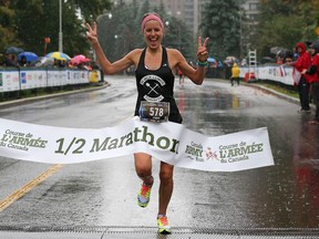 Lyndsay Tessier is the first woman to cross the finish line of the half marathon during the 2014 Canada Army Run held in Ottawa on September 21, 2014.