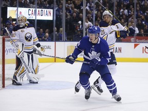 The Toronto Maple Leafs' Mitch Marner, who plays right-handed, cuts in front of Buffalo Sabres' Kyle Okposo during a game in Toronto on Feb. 25, 2019.