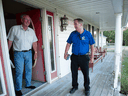 Conservative candidate Scott Armstrong, right, speaks with retired electric contractor Robert Basrkhouse while campaigning in Onslow, N.S.