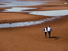 Federal Conservative leader Andrew Scheer and his wife Jill walk on the beach after making a campaign stop in Canoe Cove, P.E.I. on Sunday, September 22, 2019.