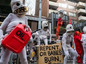 Protestors in costumes holding  a fake oil canister on September 20, 2019 in Melbourne, Australia.