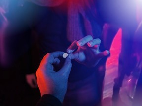 A man takes a pill from someone else at a club. Doctors are concerned at a surge in gay 'chemsex' parties, where people consume drugs and have sex with scores of people for days.