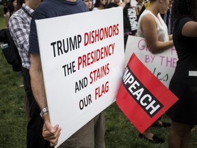 A demonstrator holds a sign at a rally hosted by Progressive Democrats of America on Capitol Hill on September 26, 2019 in Washington, DC. U.S. House Speaker Nancy Pelosi (D-CA) announced yesterday the beginning of a formal impeachment inquiry against President Donald Trump.