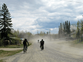 Children ride their bikes on Sandy Lake First Nation.