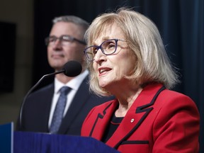 Janice MacKinnon, right, chair of the Blue Ribbon Panel on Alberta’s Finances, and Travis Toews, Minister of Finance, speak to the media about the MacKinnon Panel report on Alberta’s Finances in Calgary, Alta., Tuesday, Sept. 3, 2019.