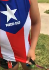 Mia Irizarry shows her shirt in a video, which features the Puerto Rico flag.