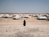 A woman walks through al-Hol camp in Syria.