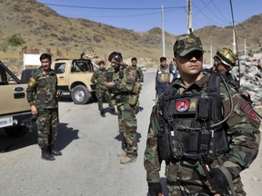 Afghan special forces stand guard at the site of a suicide car bomb explosion that killed at least four people, on the outskirts of Kabul, Afghanistan, Thursday, Sept. 12, 2019.