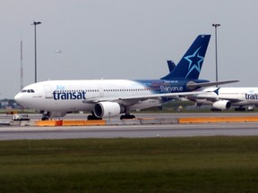 In this file photo taken on June 1, 2018, Air Transat jets prepare to take off at at MontréalPierre Elliott Trudeau International Airport in Canada.