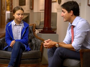 Prime Minister Justin Trudeau speaks with 16-year-old Swedish climate activist Greta Thunberg before a "climate strike" march in Montreal on Sept. 27, 2019.