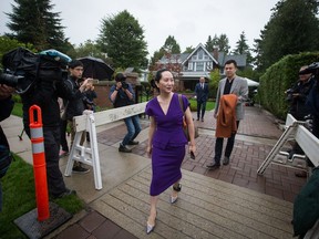 Huawei chief financial officer Meng Wanzhou, centre, who is out on bail and remains under partial house arrest after she was detained last year at the behest of American authorities, and her husband Liu Xiaozong, back right, leave their home to attend a court hearing in Vancouver, on Monday September 23, 2019.