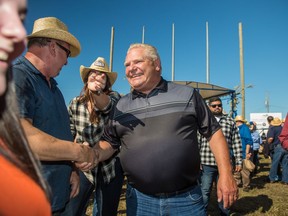 Ontario Premier Doug Ford welcomes visitors to the International Plowing Match in Verner, Ont. during the opening parade on Tuesday, September 17, 2019.