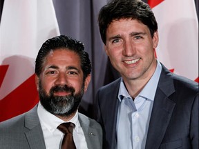 Prime Minister Justin Trudeau and Montreal restaurateur Waseem Ramli. a supporter of Syrian President Bashar al-Assad, are seen in a photo taken at a Liberal party fundraiser and posted on Facebook by Ramli.