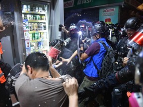 Riot police officers clash with pro-democracy protesters in Yeun Long district in Hong Kong on September 21, 2019. - Riot police and protesters fought brief skirmishes in a town close to the Chinese border on September 21, the latest clashes during huge pro-democracy protests that have battered the financial hub for more that three months.