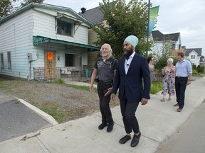 NDP Leader Jagmeet Singh, joined by area residents, tours a neighbourhood damaged by recent flooding during a campaign stop in Gatineau, Que. on Sunday, Sept. 22. 2019.
