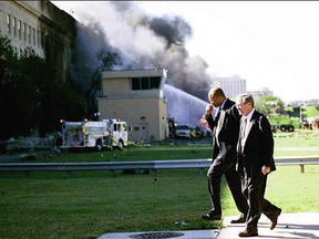 Defense Secretary Donald Rumsfeld walks back into the Pentagon after helping at the crash site on Sept. 11, 2001.