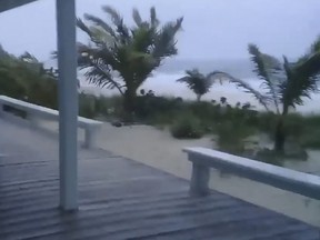 This video grab handout Facebook image obtained September 1, 2019 courtesy of Rich Roberts shows storm activity in Man-O-War Cay,Abaco Islands, Bahamas. - Hurricane Dorian strengthened into a catastrophic Category 5 storm Sunday, packing 160 mph (267 kph) winds as it was about to slam into the Abaco Islands in the Bahamas, US weather forecasters said."#Dorian is now a category 5 #hurricane with 160 mph sustained winds," the Miami-based National Hurricane Center said in a tweet."The eyewall of this catastrophic hurricane is about to hit the Abaco Islands with devastating winds," it said.