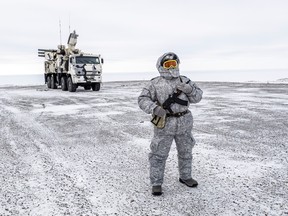 A soldier holds a machine gun as he patrols the Russian northern military base on Kotelny island, beyond the Arctic circle on April 3, 2019.