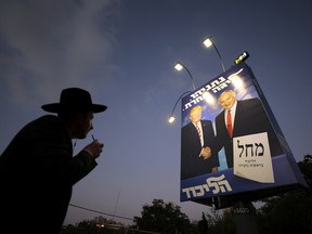 An ultra-Orthodox Jewish man walks past a Likud party election campaign banner depicting Israeli Prime Minister Benjamin Netanyahu and U.S. President Donald Trump in Jerusalem September 11, 2019.