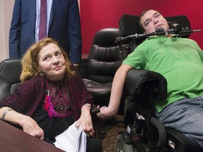 Nicole Gladu, left, and Jean Truchon attend a news conference in Montreal, Thursday, September 12, 2019, where they gave their reaction to a Quebec judge overturning parts of provincial and federal laws on medically assisted dying.