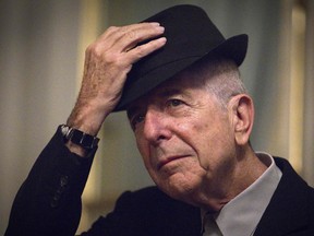 Canadian singer and poet Leonard Cohen takes off his hat to salute in Paris on January 16, 2012.