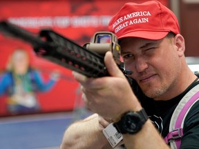 An attendee sites down a semiautomatic rifle at the National Rifle Association's (NRA) annual meeting, in Indianapolis, Indiana, U.S., April 28, 2019.