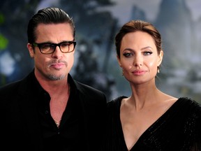 This file photo taken on May 8, 2014 shows U.S. actress Angelina Jolie (R) along with her husband US actor Brad Pitt as they arrive for the premiere of the film "Maleficent" at Kensington Palace in London.