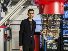 This undated handout image obtained October 23, 2019 courtesy of Google shows Sundar Pichai with one of Google's quantum computers in the Santa Barbara lab.