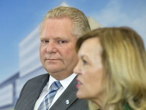 Ontario Premier Doug Ford watches as Health Minister Christine Elliott speaks at an event at the Centre for Addiction and Mental Health in Toronto on January 30, 2019.