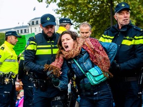 An activist is arrested by the police during a blockade organized by Extinction Rebellion activists in Amsterdam, on October 7, 2019.