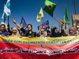 Syrian Kurds take part in a demonstration against Turkish threats in Ras al-Ain town in Syria's Hasakeh province near the Turkish border on October 9, 2019.