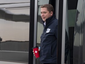 Conservative leader Andrew Scheer steps off a bus as he arrives at the airport in Mirabel, Que. Wednesday October 16, 2019.