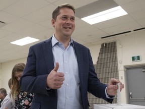 Conservative leader Andrew Scheer gives the thumbs up as he casts his ballot at a polling station in his riding in Regina, Monday October 21, 2019.