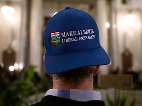 A man wears an anti-Liberal hat in the rotunda of the Alberta Legislature, after the province's 2019 budget was delivered, in Edmonton on Oct. 24, 2019.