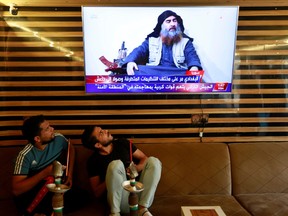 Iraqi youth watch the news of Islamic State leader Abu Bakr al-Baghdadi death, in Najaf, Iraq October 27, 2019.