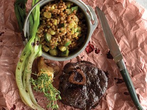 Braised venison shanks with mossberry black garlic glaze and herbed wheat berries