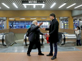 Newly re-elected Prime Minister Justin Trudeau greets commuters in a Montreal metro station on the morning of Tuesday, October 22, 2019.