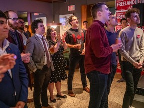 Liberal supporters cheer as election results begin to come in, at the closing party of Liberal incumbent candidate Chrystia Freeland, during  Canada's 43rd general election, in Toronto, Ontario, Canada, at The Peacock Public House, October 21, 2019.
