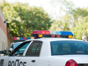 Police cars are parked on a street. An Arizona man faces felony murder charges after he drowned his son in a bathtub, claiming he needed to be rid of his demons.
