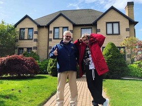 American rapper Aaron Carter (R) poses with real estate agent Mike Randall (L) in front of a property he alleges to have purchased in Yarmouth, Nova Scotia.