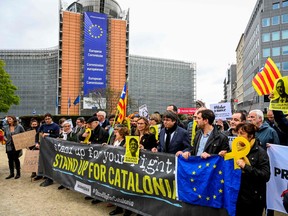 Catalan leader in exile Carles Puigdemont (3rdR) attends a protest in Brussels after Spain's Supreme Court sentenced nine separatist leaders from Catalonia, on October 15, 2019.