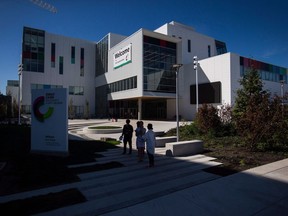 People stand outside the new Emily Carr University of Art and Design campus in Vancouver, B.C., on Friday September 1, 2017. The university campus remains closed today following a small fire Saturday morning.