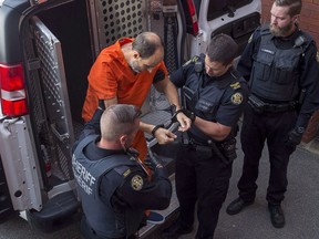 Matthew Vincent Raymond, charged with four counts of first degree murder, arrives at provincial court in Fredericton on Monday, Aug. 27, 2018. Jury selection is complete for a hearing to determine if Matthew Raymond is fit to stand trial on four counts of first-degree murder.