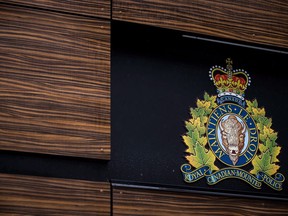 The RCMP logo is seen outside Royal Canadian Mounted Police "E" Division Headquarters, in Surrey, B.C., on April 13, 2018. A bail hearing is underway for Cameron Jay Ortis, a senior RCMP official accused of breaching official-secrets law. Ortis, 47, faces charges of violating the Security of Information Act and breach of trust for allegedly trying to disclose classified information to an unspecified foreign entity or terrorist group.