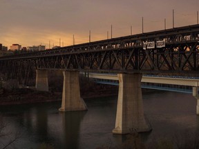 An anti-pipeline message on a banner hangs from a High Level bridge in Edmonton, Alta., on Friday, October 6, 2017. A legal advocacy group is suing the City of Edmonton for a decision to cancel a lighting of the High Level Bridge in the colours of the Alberta March for Life Association.