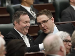Alberta Premier Jason Kenney and Jason Nixon Minister of Environment and Parks chat before the speech from the throne is delivered in Edmonton on Tuesday May 21, 2019. Alberta's Government House Leader says new rules are being introduced this fall on farm safety and on reducing large-scale greenhouse gas emissions.