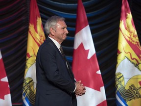 New Brunswick Premier Blaine Higgs walks onto stage to deliver the State of the Province address in Fredericton on Thursday January 31, 2019. New Brunswick's Progressive Conservative premier says voters delivered a message Monday on the federal carbon tax, and his province will have to find a way to make it work.